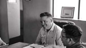 Grayscale Photo Of Man Sitting On Chair 1325759