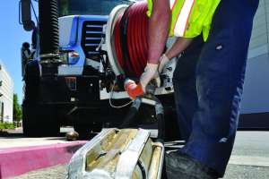 Austin Welch Prepares To Insert An Ejector Nozzle Into A 48 Inch Siphon