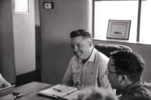 Grayscale Photo Of Man Sitting On Chair 1325759